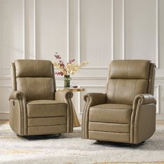 two recliners sitting next to each other on a rug in front of a white wall