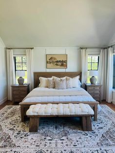 a large bed sitting in the middle of a bedroom