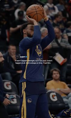 a man holding a basketball in his right hand while wearing a blue and yellow uniform