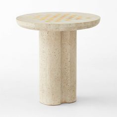 a white marble table with yellow dots on the top and bottom, sitting in front of a white background