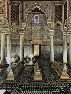 an ornate room with columns and tiled walls