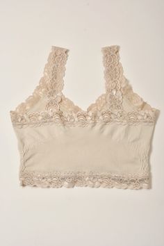 A lightweight cami with lace trim detailing Brand: M. Rena Fabric Content: 92% Nylon | 8% Spandex Size + Fit: One size Beige Stretch Camisole With Bra-friendly Design, Stretch Lace Top With Built-in Bra, Lace Cami Tank Top With Lace Trim, Stretch Lace Tops With Seamless Design, Seamless Stretch Lace Tops, Fitted Solid Camisole With Lace Trim, Stretch Lace Cami Tank Top, Fitted Lace Tank Top With Crochet Trim, Stretch Lace Tops Bra Friendly