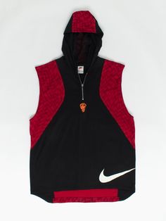 90s vintage Nike basketball vest / sleeveless hoodie black and red zig zag print. This Nike basketball hoodie features a red zigzag pattern, a quarter zip, mesh fabric inside the hood and the classic big swoosh Nike tick at the bottom of the jersey. Cool orange embroidered basket ball and hoop at base of zip. Perfect for shooting some hoops or general streetwear. Our recommended size: Large Label says: Large Condition: Very good Material (body): 100% cotton Material (lining): 100% polyester Meas Hooded Sports Vest, Black Hooded Vest For Streetwear, Hip Hop Hooded Sports Tops, Hooded Hip Hop Sports Top, Red Cotton Sports Vest, Hooded Vest Top For Streetwear, Hip Hop Sports Hoodie, Sportswear Vest For Streetwear, Hooded Casual Vest For Streetwear