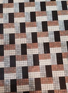 a close up of a tiled floor with brown and white tiles