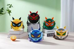 five different types of masks sitting on top of each other next to an orange slice