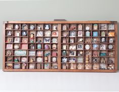 a wooden shelf filled with lots of different types of clocks