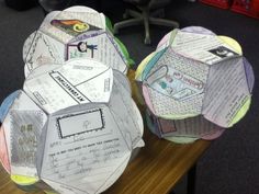 two paper balls sitting on top of a wooden table