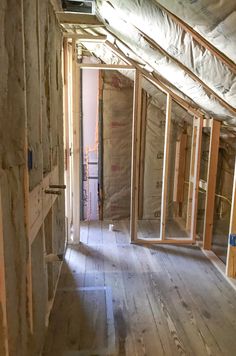 an unfinished room with wooden floors and walls