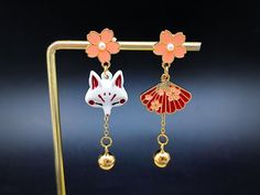 asymmetrical kitsune earrings Japanese fox mask dangling with Japanese sakura cherry blossom Japanese fox jewelry with silver stems Kitsune Earrings, Clay Diys, Japanese Fox Mask, Earrings Japanese, Japan Jewelry, Japanese Fox, Fox Jewelry, Japanese Sakura, Fox Mask