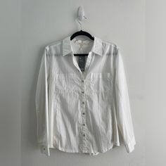 Eileen Fisher Classic White Button Down Collared Poplin/Pajama Style Long Sleeve Shirt, Size S. New With Tags. Classic, Sustainable, Eco, Organic Cotton, Timeless, Mature, Staple, Lagenlook, Minimal Flaws To Note: Small Marks/Stains On Front Left Small Mark On Right Collar Small Hole Close To Inside Style Tag All As Shown In Photos. Features: Button Up / Button Down Collar Mother Of Pearl Style Iridescent Buttons Two Chest Pockets - Poplin Pajama Shirt Style Subtle U Hem Unique Mixed Media Garme Casual Button-up Sleepwear For Spring, Casual White Button-up Sleepwear, Cotton Button-up Sleepwear, Collared Cotton Sleepwear With Button Closure, Spring Loungewear Shirt With Button Closure, Collared Shirt With Buttons For Loungewear, Casual Cotton Button-up Sleepwear, Spring Button-up Sleepwear With Pockets, Casual Cotton Sleepwear With Button Closure