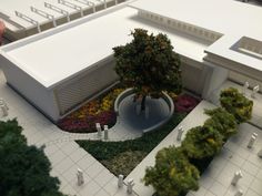 a model of a building with trees and bushes