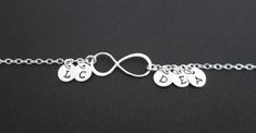 "♥ This bracelet is for a sterling silver infinity bracelet with 5 personalized sterling silver discs ♥ Contains small parts. Not intended for kids under age of 6 ♥ Sterling silver chain & clasp ♥ 9 x20mm sterling silver infinity charm ♥ 6mm sterling silver discs ♥ Solid sterling silver bracelet ♥ Please indicate your desired initials in the \"Note to Seller\" box, thank you ♥ Displayed bracelet shows DK Uppercase Kristen initials of \"L\", \"C\", \"D\", \"E\" & \"A\" ♥ Bracelet size is Customizable Silver Charm Bracelet, Customizable Silver Name Bracelet, Customizable Silver Round Name Bracelet, Customizable Sterling Silver Round Bracelets, Customizable Sterling Silver Bracelets, Customizable Round Sterling Silver Bracelets, Customized Silver Name Bracelet, Silver Name Jewelry For Friendship, Silver Sterling Silver Name Charm Bracelet