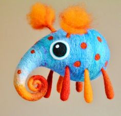 a blue and orange stuffed animal hanging from a string