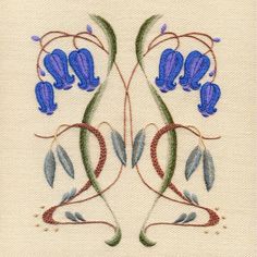 an embroidered design with blue flowers and leaves