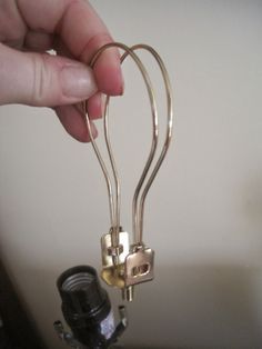 a person is holding onto some kind of metal object with two keys attached to it