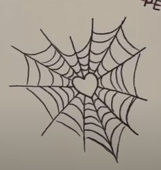 a spider web with a heart drawn on it