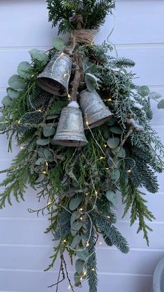 a christmas wreath with bells hanging from it