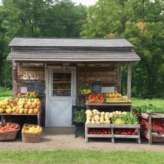 an outdoor produce stand with fruits and vegetables