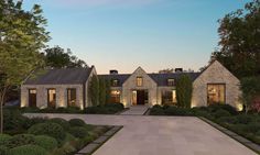 an artist's rendering of a house in the evening with its driveway and landscaping