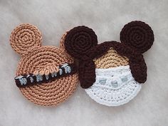 two crocheted mickey and minnie mouse hats on top of each other with ears