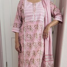 This floral printed straight kurta set is a delightful fusion of elegance and charm, featuring vibrant floral patterns that add a touch of whimsy to the ensemble. It comes with a pair of straight pants. The kurta has a round neckline, three-quarter sleeves, side slits, and a curved hemline, while the pants have an elasticated waistband. With its flattering silhouette and coordinated design, this kurta set offers a versatile and stylish option for various occasions. This beautiful soft 100% cotto Diwali Floral Print Sets With Straight Kurta, Floral Print Mulmul Sets For Festivals, Bollywood Style Straight Kurta Sets For Spring, Festival Floral Print Mulmul Sets, Festive Floral Print Mulmul Sets, Floral Print Mulmul Sets With Straight Kurta, Spring Block Print Straight Kurta Set, Cotton Floral Print Salwar Kameez For Festivals, Floral Print Cotton Salwar Kameez For Festivals