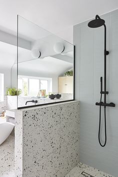 a bathroom with a sink, mirror and bathtub