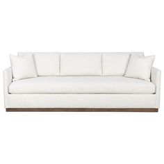 a white couch with pillows on it