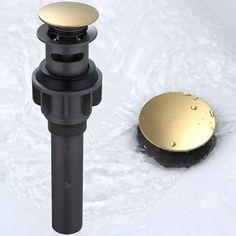 a black and gold sink faucet sitting on top of a white surface