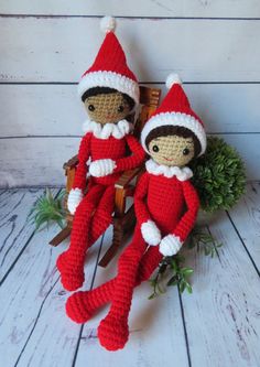 two crocheted elves sitting next to each other