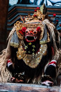 an elaborately decorated lion statue sitting in front of a building