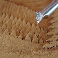 a close up of a pen on a piece of wood with diamond trimmings