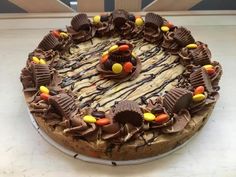 a cake with chocolate frosting and candy candies on it's top, sitting on a table