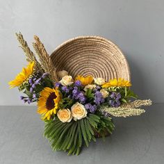 a basket filled with flowers sitting on top of a table