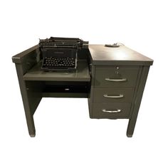 an old fashioned desk with a vintage typewriter on it's top and drawers