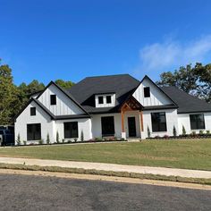 a large white house sitting on the side of a road