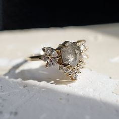 a diamond ring sitting on top of a white surface