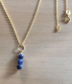 Dainty Blue Sodalite Pendant and Chain Necklace, Genuine Semiprecious Gemstone 14K Gold Filled Round Trio 3 Beads Natural Minimalist Gift This necklace is dainty, simple and versatile.  Our trio of genuine Sodalite beads and chain necklace have a mix of beautiful swirls of medium blue and dark blue color.  The beads are very small and lightweight.   Depending on the length of chain you select, can be worn as a choker or longer.  Can be worn as an Everyday Necklace, neutral,  versatile and minima Blue Sodalite, Minimalist Gifts, Wire Pendant, Everyday Necklace, Dark Blue Color, Gold Wire, Natural Beads, Semi Precious Gemstones, Shades Of Blue