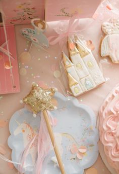 a table topped with lots of pink and gold decorations