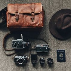 an old camera and other items are laid out on the floor next to each other