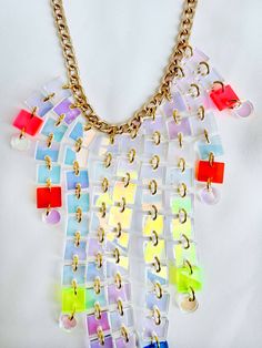 Pride is all about being loud and fun, and this necklace is that and MORE! Length: 17" - 20" Material: Gold Plated Aluminum Chain; Transparent Neon Pink, Rust, Acid, Blue, Purple, & Iridescent Acrylic Handmade in NYC, ready to ship! We are a small team: processing takes between 1-10 business days, depending on the number of orders. Thank you for your patience! Shipping and Returns policy All sales items are final sale Have questions/need help? We're here for you! help@islynyc.com or reach out in Bold Necklace For Party, Unique White Necklaces For Party, Unique Multicolor Necklaces, Unique White Necklace For Party, Handmade Bold Necklace For Party, Multicolor Chain Jewelry, Unique Multicolor Chain Jewelry, Bold Handmade Necklace For Party, Party Necklace With Adjustable Chain In Clear Color