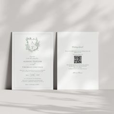 an elegant wedding card with a monogrammed wreath on the front and back side