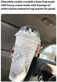 a person holding up a drink in the back seat of a car with text that reads, chocolate cookie crumble creme frap trap made with cream made with 8 pumps of white mocha instead of