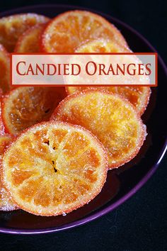 candied oranges on a plate with the words candied oranges