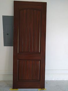 a wooden door sitting in the corner of a room