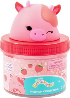 an animal shaped container with strawberrys on the lid and a pink pig's head sticking out of it