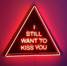 a neon sign that says i still want to kiss you on the inside of it