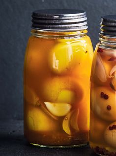 two jars filled with liquid and food items