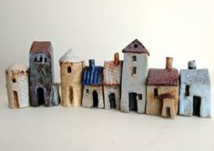 small ceramic houses lined up on a white surface