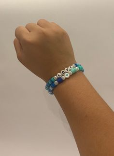 This beautiful bracelet features a lovely combination of blue and green beads, creating a vibrant and eye-catching accessory that is perfect for adding a pop of color to any outfit. Handcrafted with care, this bracelet is not only stylish but also durable, making it a versatile piece that can be worn for any occasion. Add a touch of elegance to your look with this stunning stretchy clay bead bracelet. Trendy Blue Jewelry With 8mm Beads, Trendy Blue 8mm Beaded Jewelry, Blue Beaded Bracelets With 8mm Beads For Beach, Blue Stretch Bracelet With Colorful Beads, Turquoise Bracelets With Heart And Round Beads, Trendy Hand-strung Blue Beads, Trendy Turquoise Beaded Stretch Bracelet, Trendy Blue Hand-strung Beads, Casual Multicolor Beaded Evil Eye Bracelet