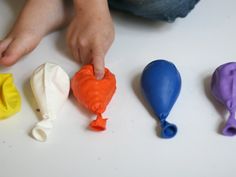 the child is playing with plastic toys on the table